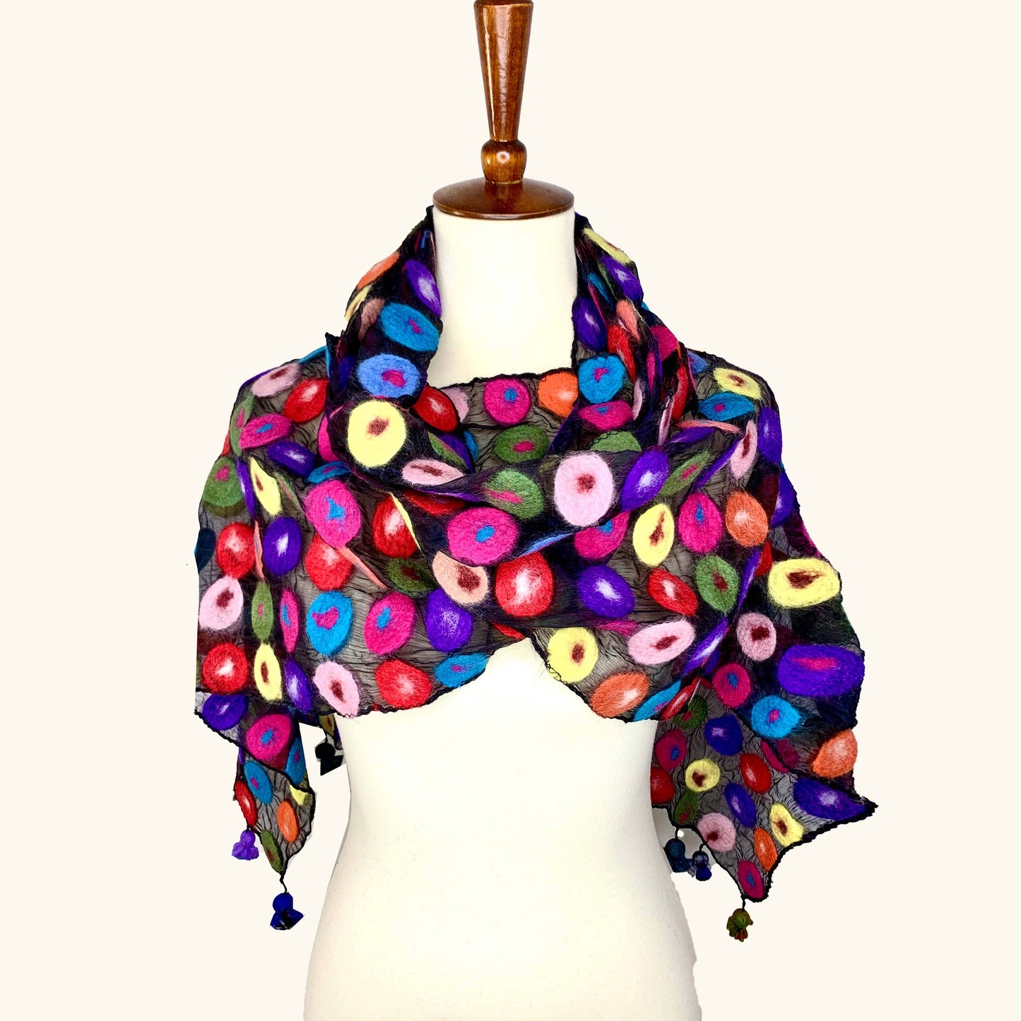 Colorful floral-patterned scarf on a mannequin against a white background