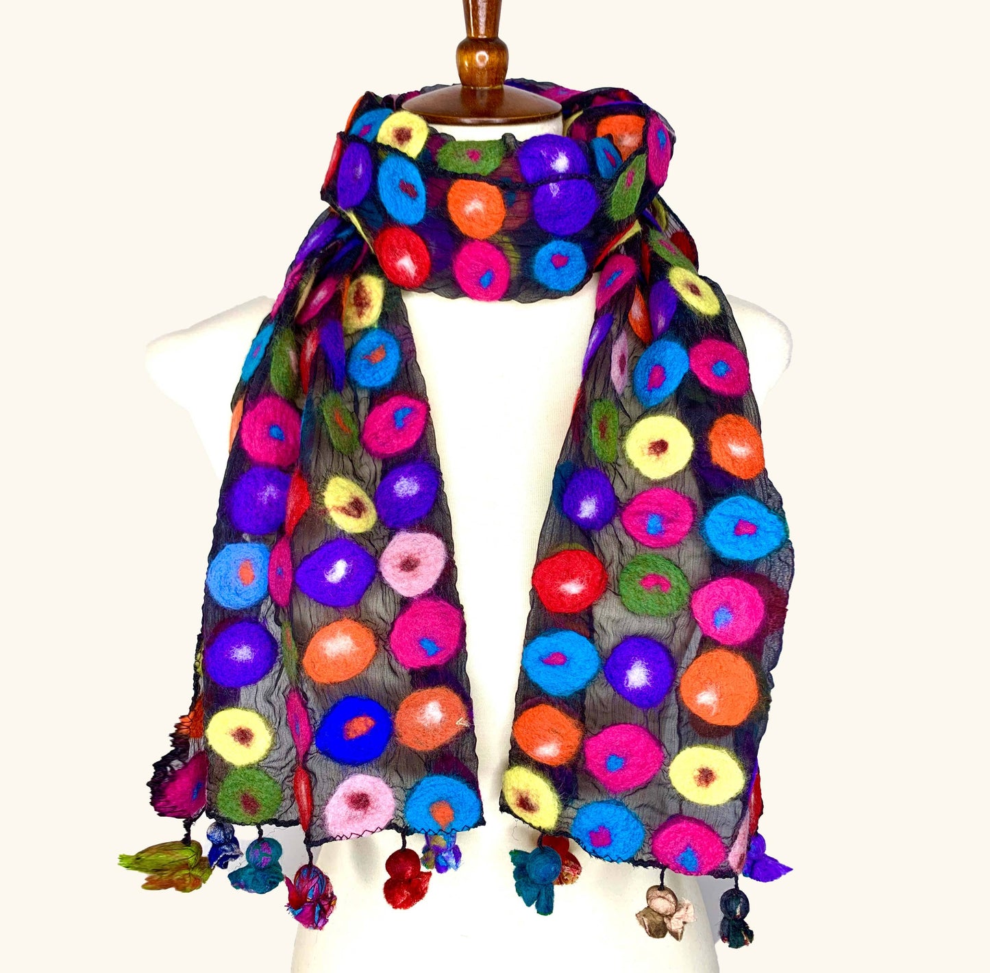 Colorful floral patterned scarf on a mannequin against a white background, front view