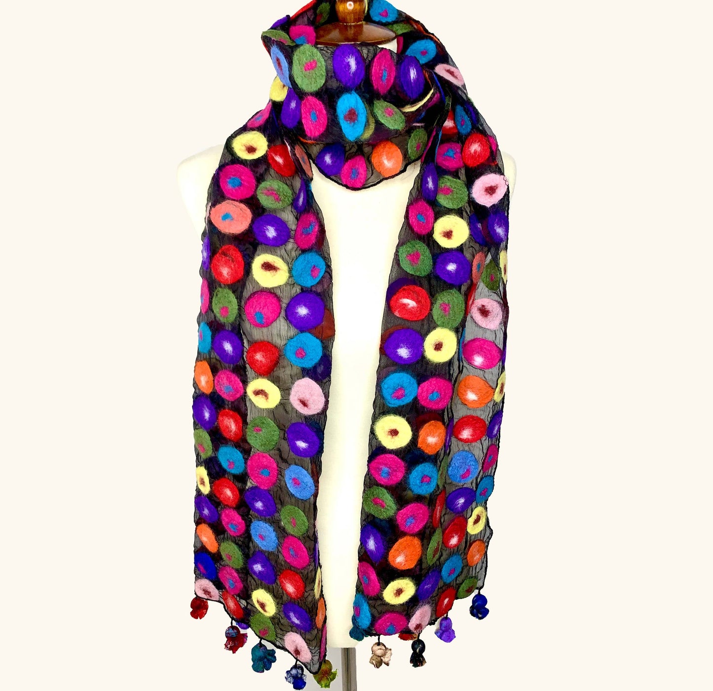 Colorful patterned scarf with tassels on a white background