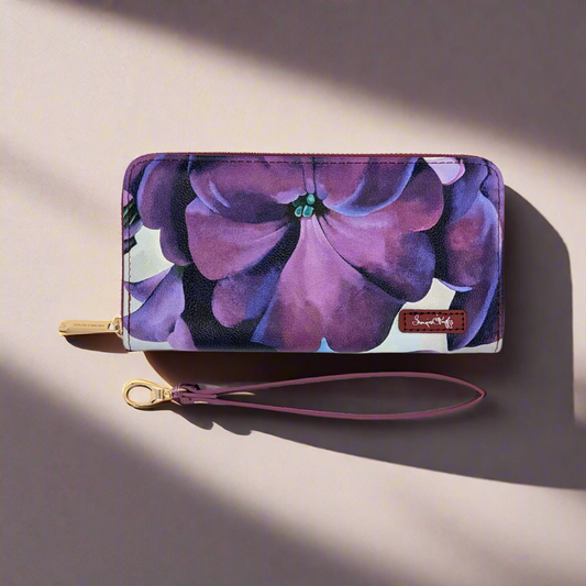 Georgia O'Keeffe Petunia Wristlet Wallet featuring vibrant floral artwork on textured vegan leather with multiple compartments and removable wrist strap